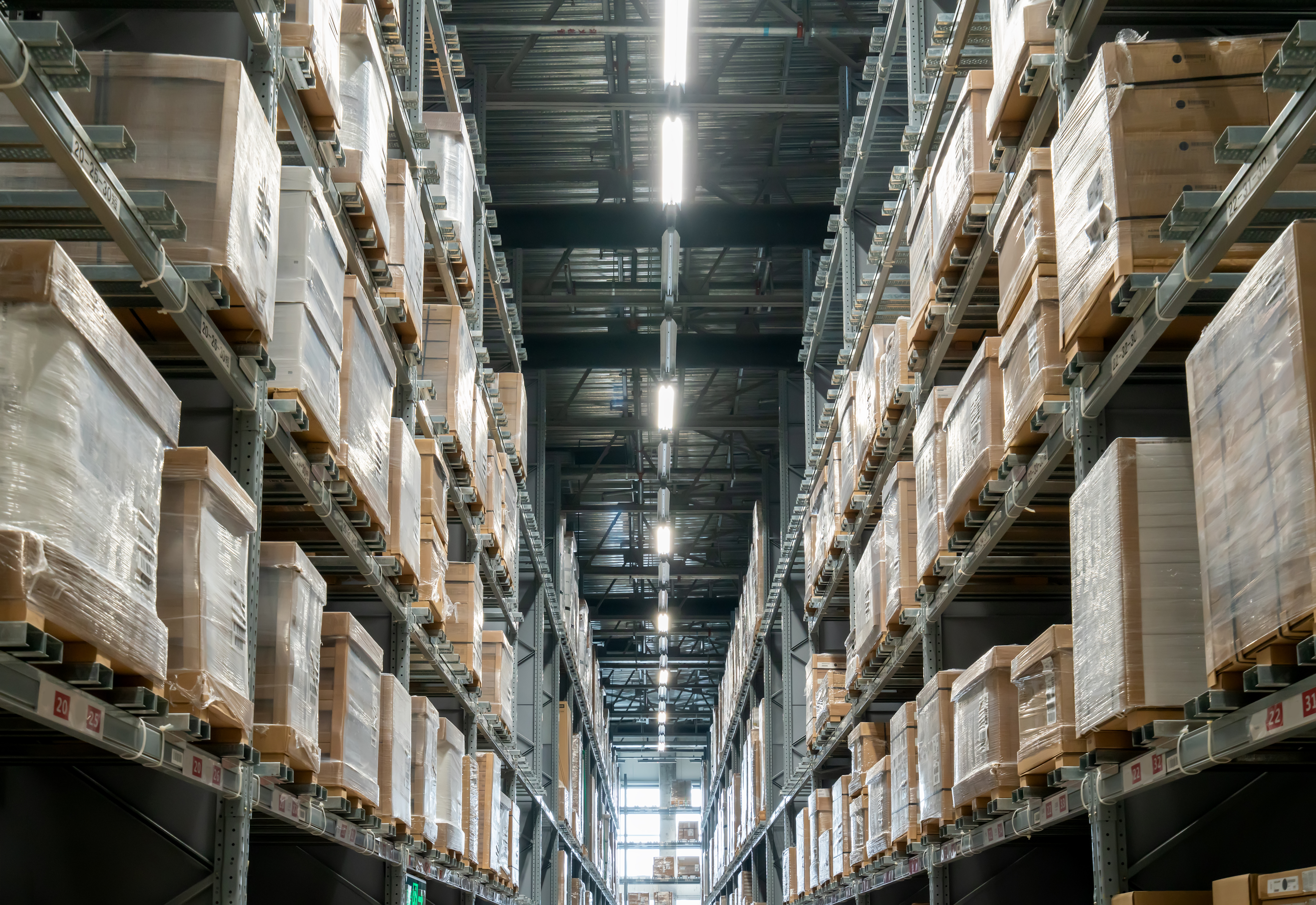 A warehouse filled with shipping pallets on shelves
