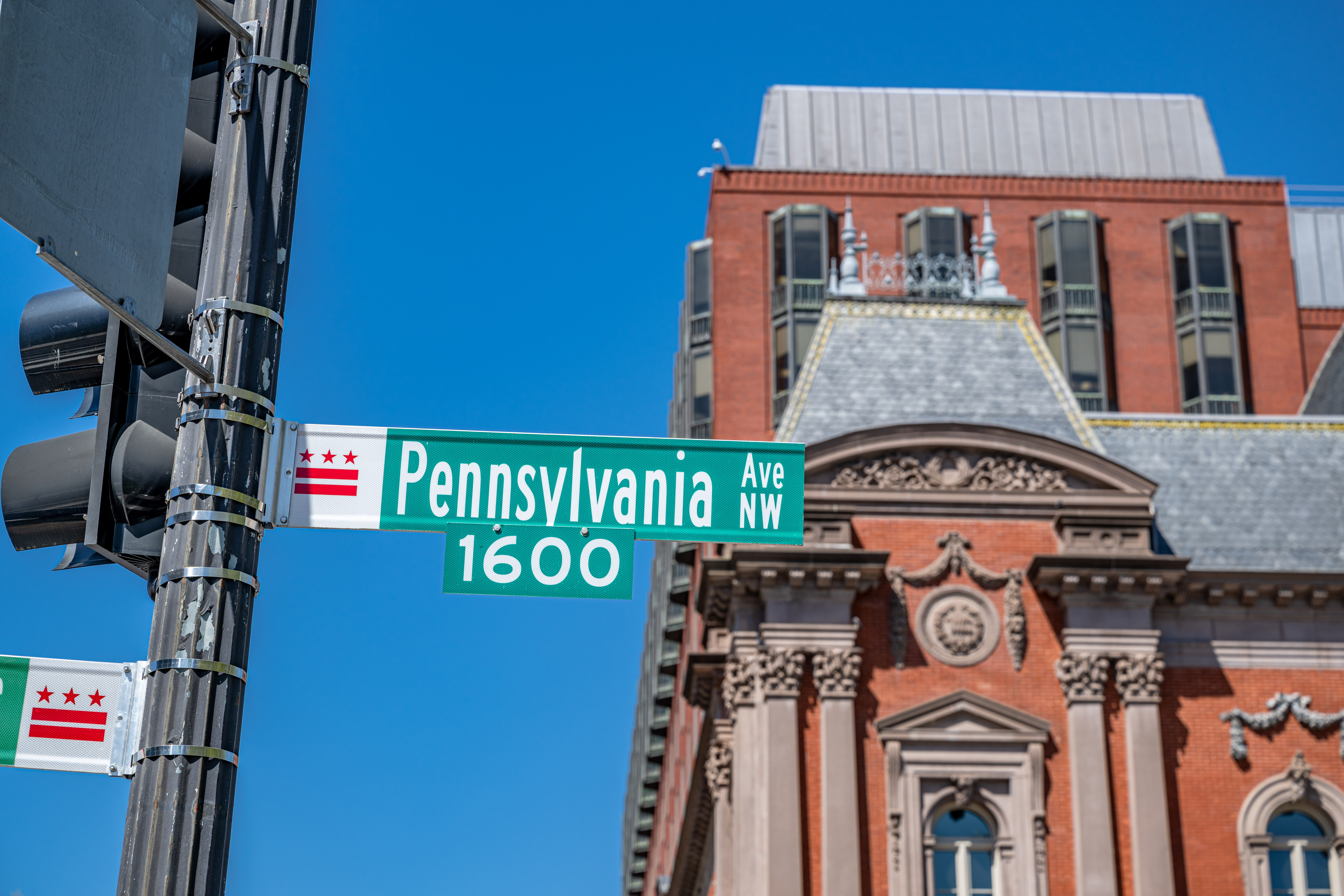 A Pennsylvania street sign in front of a historic building on a sunny day