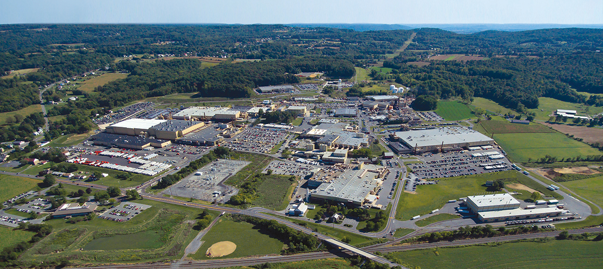 Aerial image of a large manufacturing facility in a lush valley in Pennsylvania