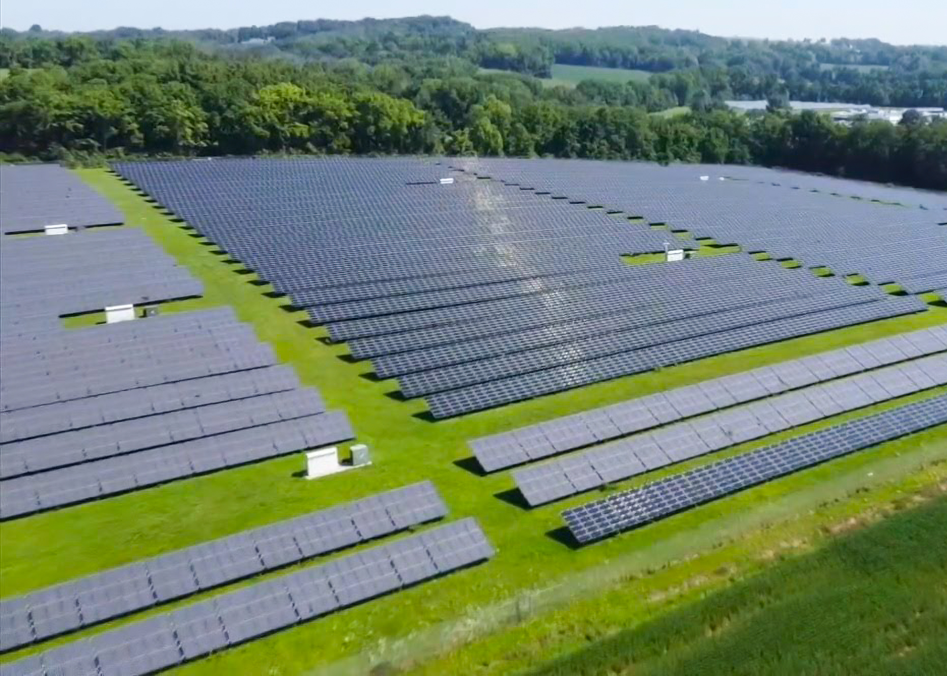 Large solar farm in green rural landscape