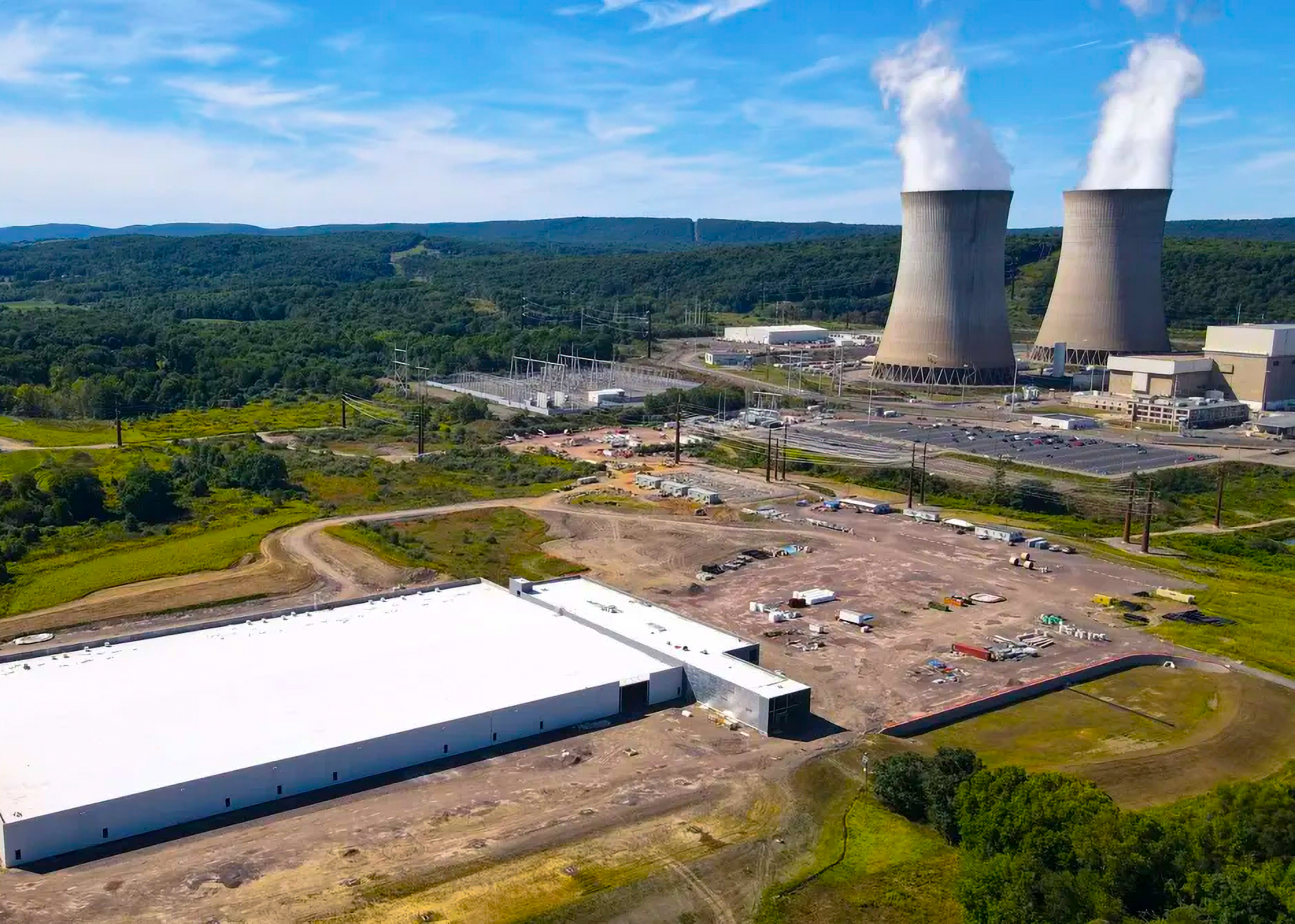 Nuclear power plant with cooling towers in rural landscape