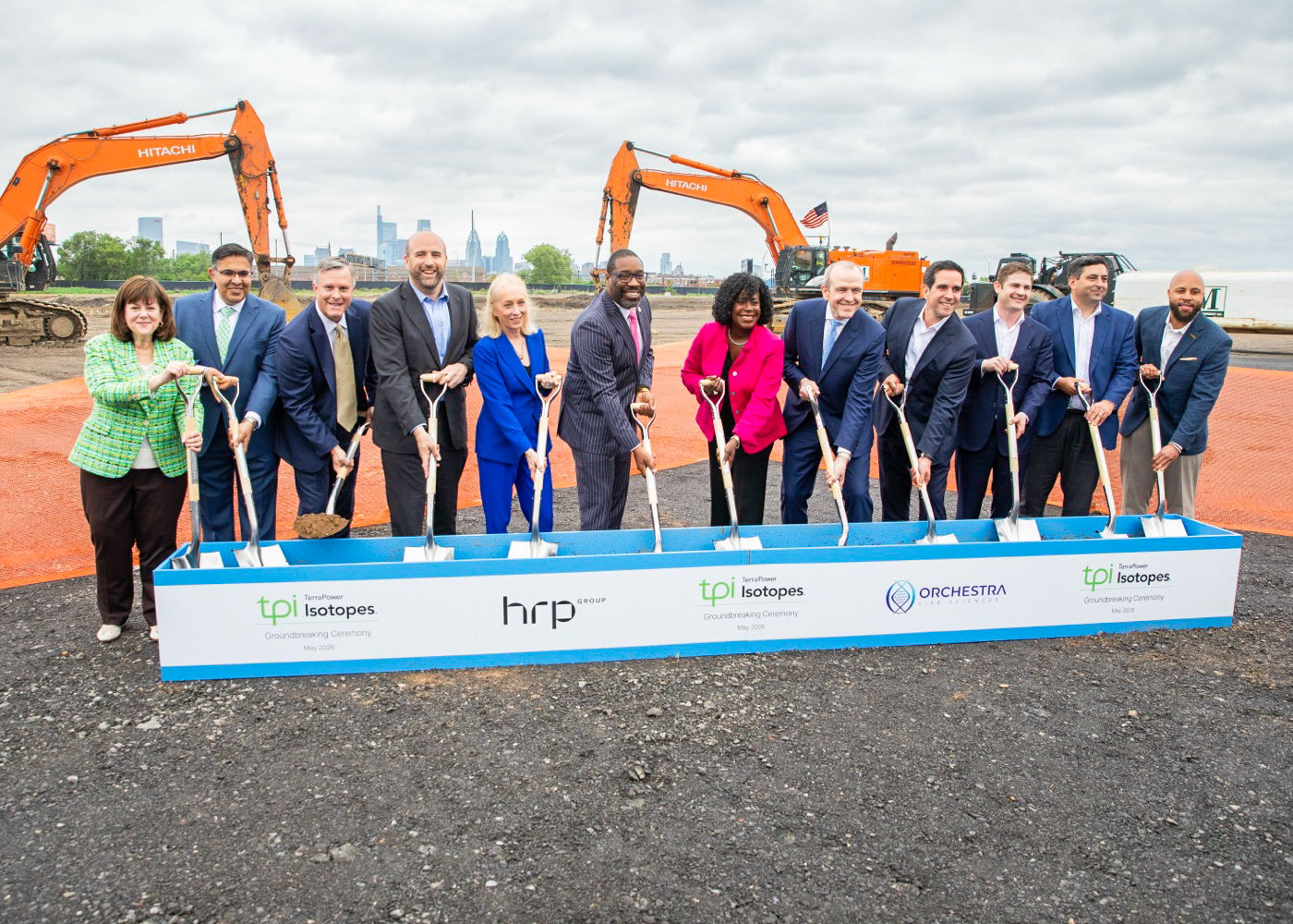 Executives participate in ceremonial groundbreaking event at a construction site.