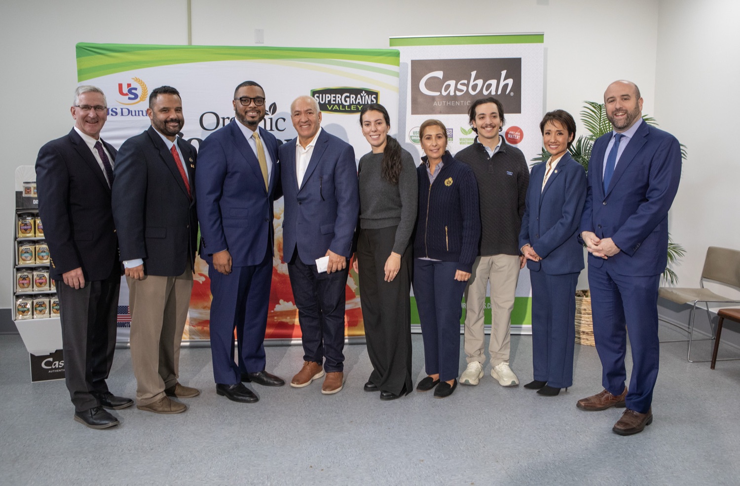 Lieutenant Gov, Austin Davis, DCED Sec. Rick Siger, and other state officials and businesspeople pose for a group photo in a meeting room.
