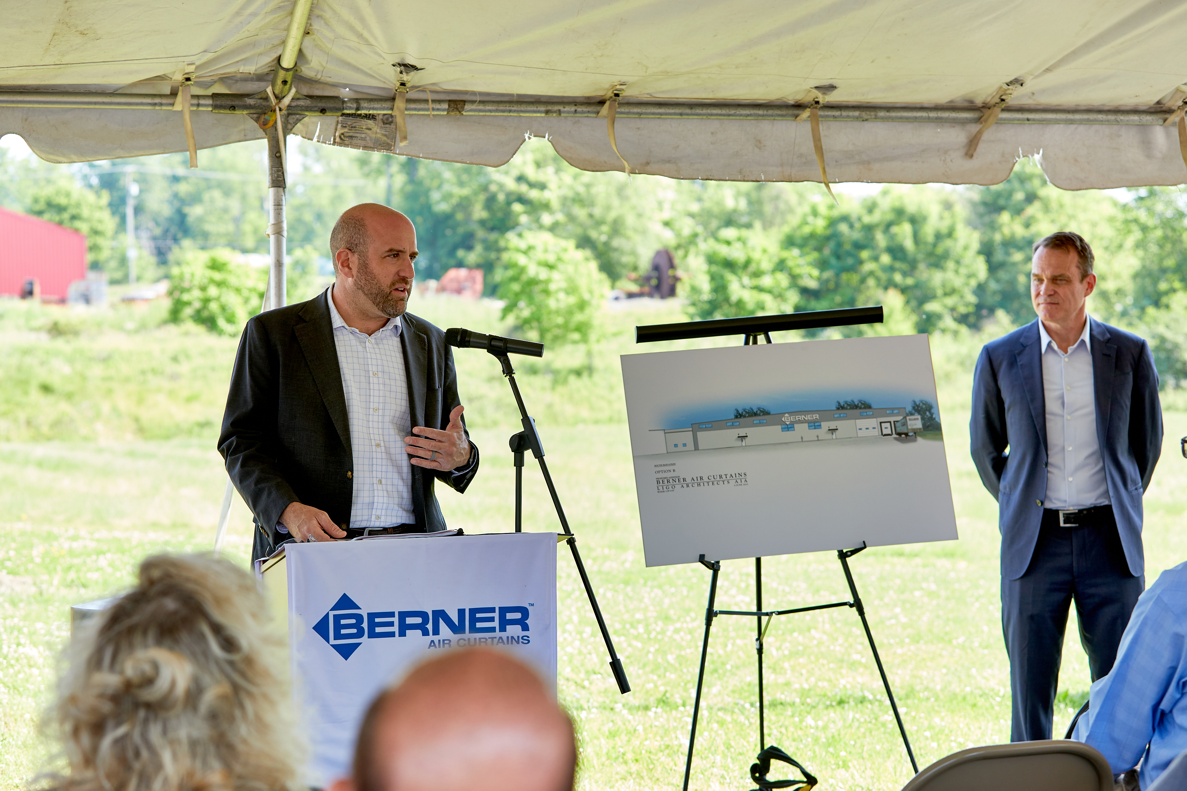 Secretary Rick Singer giving a speech behind podium at Berner ground breaking event.