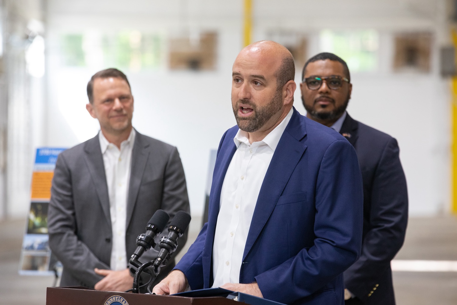 Pennsylvania Governor Josh Shapiro speaking from a podium at Premier Automation