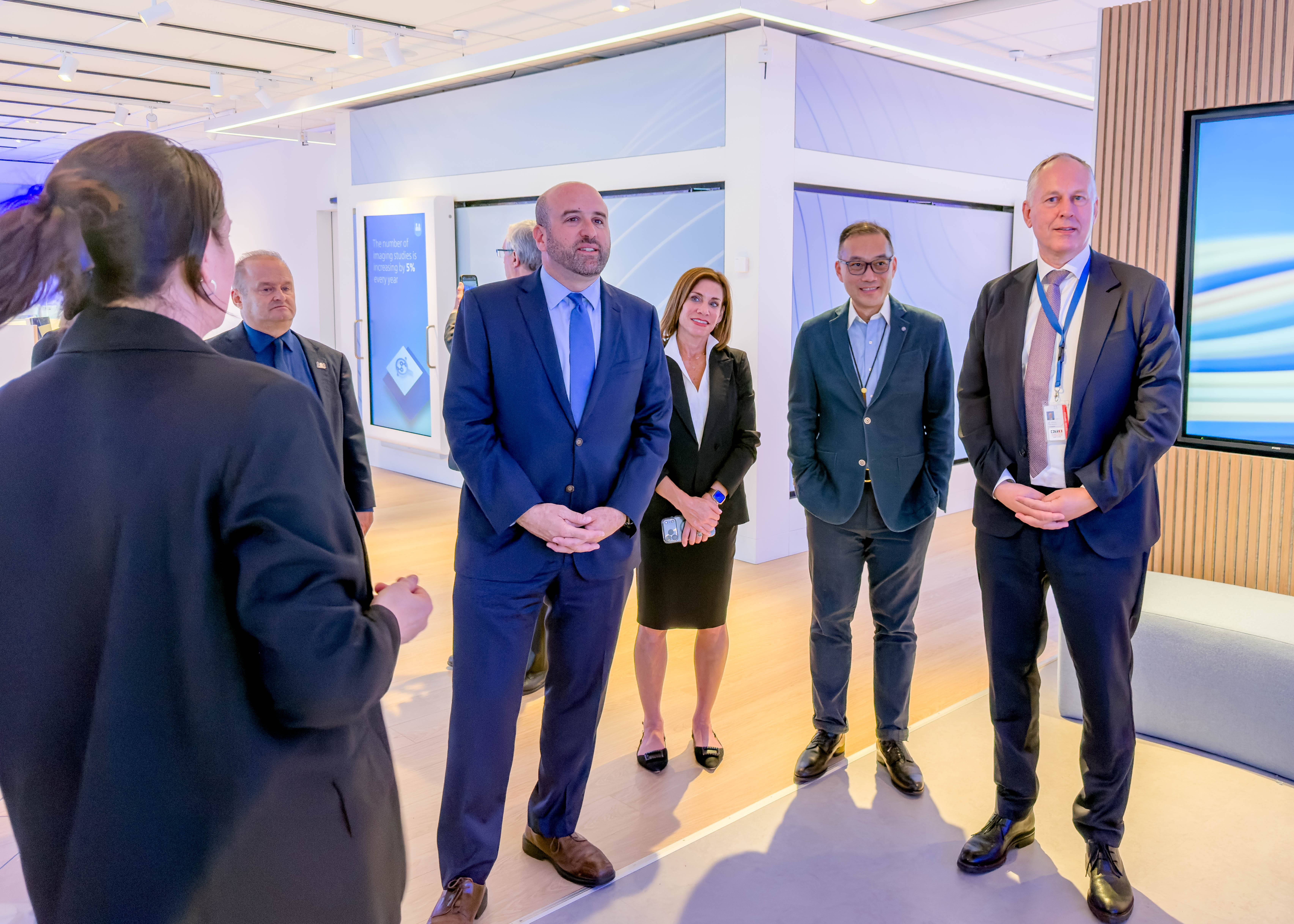 DCED Secretary Rick Siger and a group of businesspeople tour a modern life sciences exhibit hall.