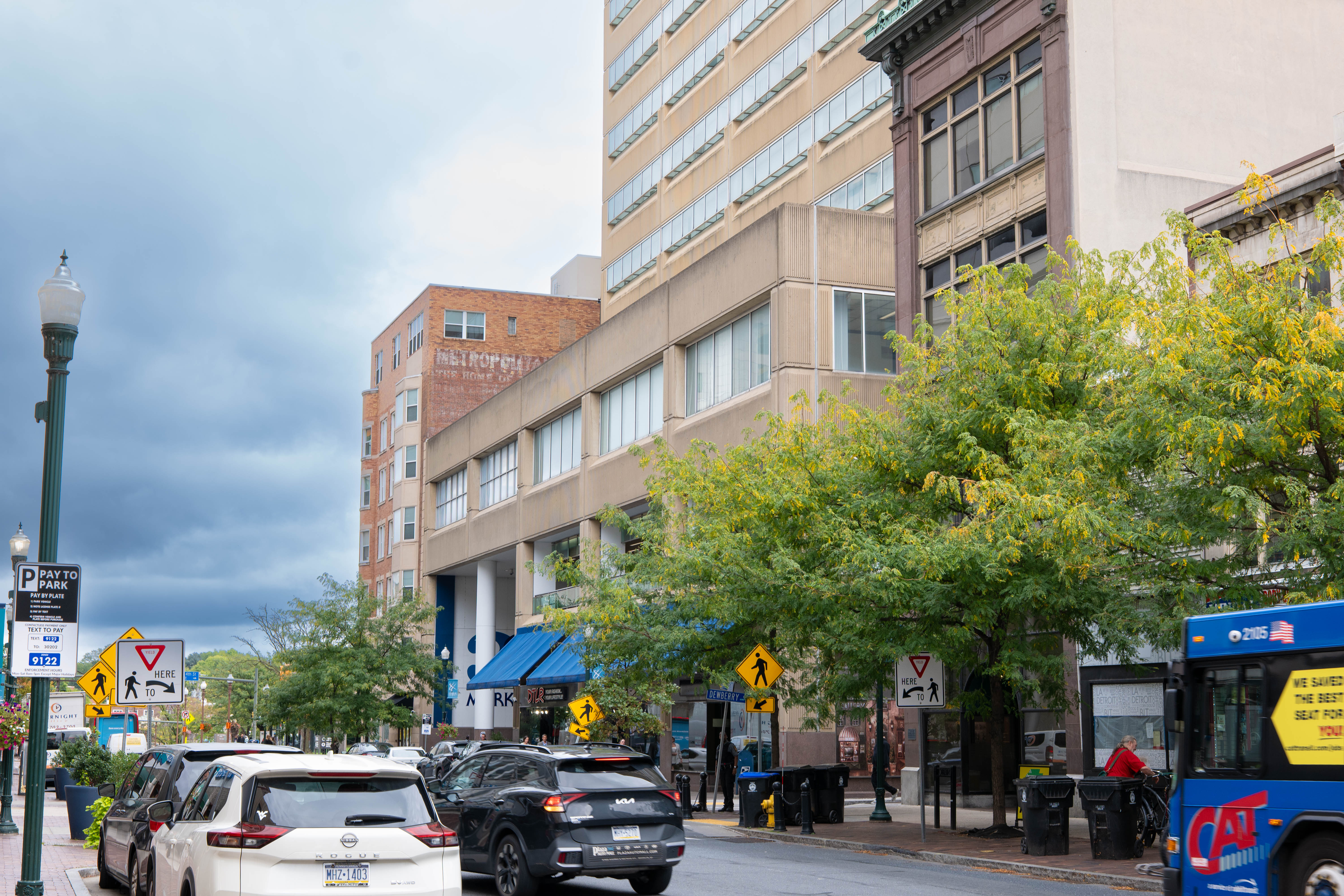 Vehicles drive through city streets in downtown Harrisburg on a cloudy day