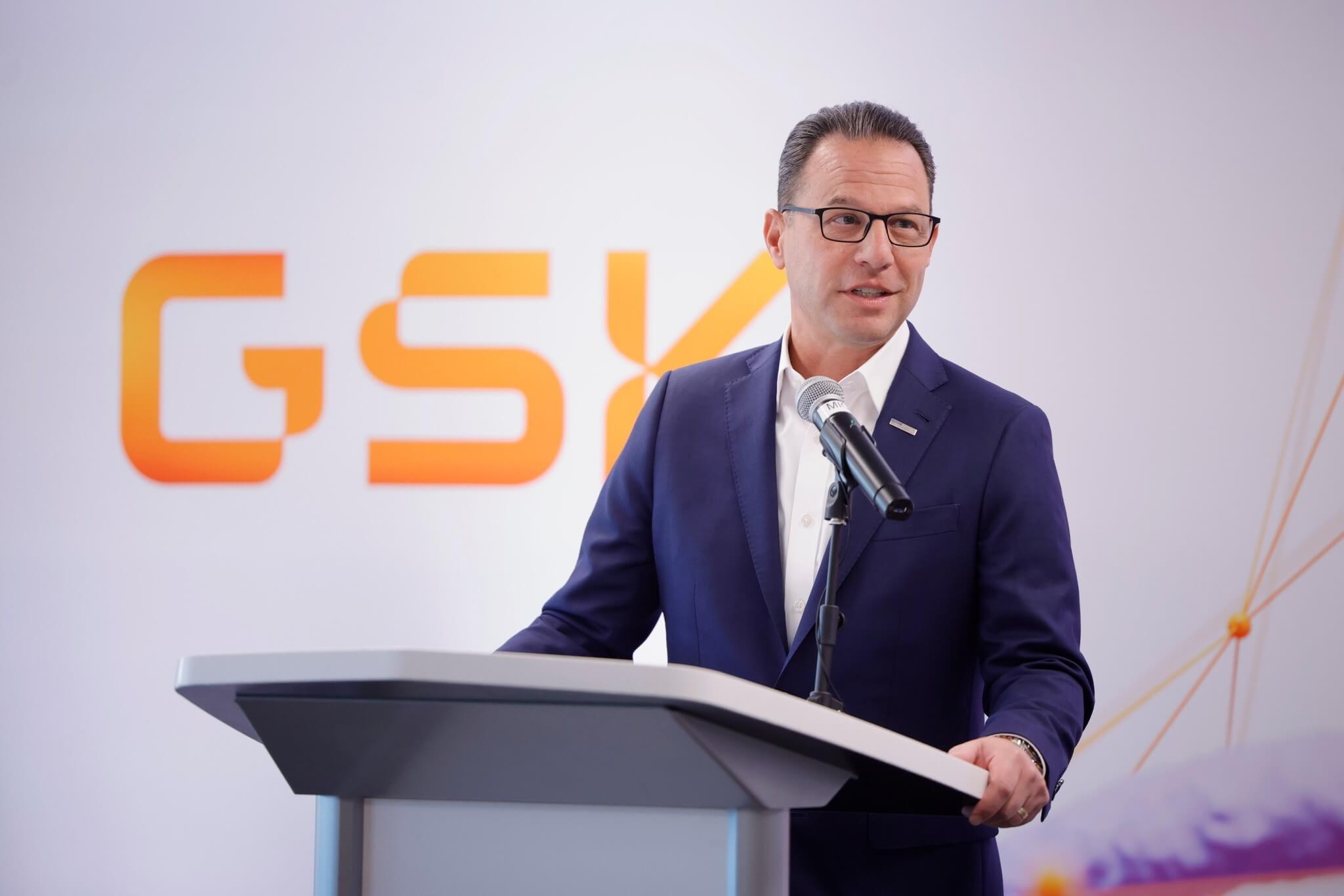 Governor Josh Shapiro speaks at a podium. The GSK logo is visible behind him.