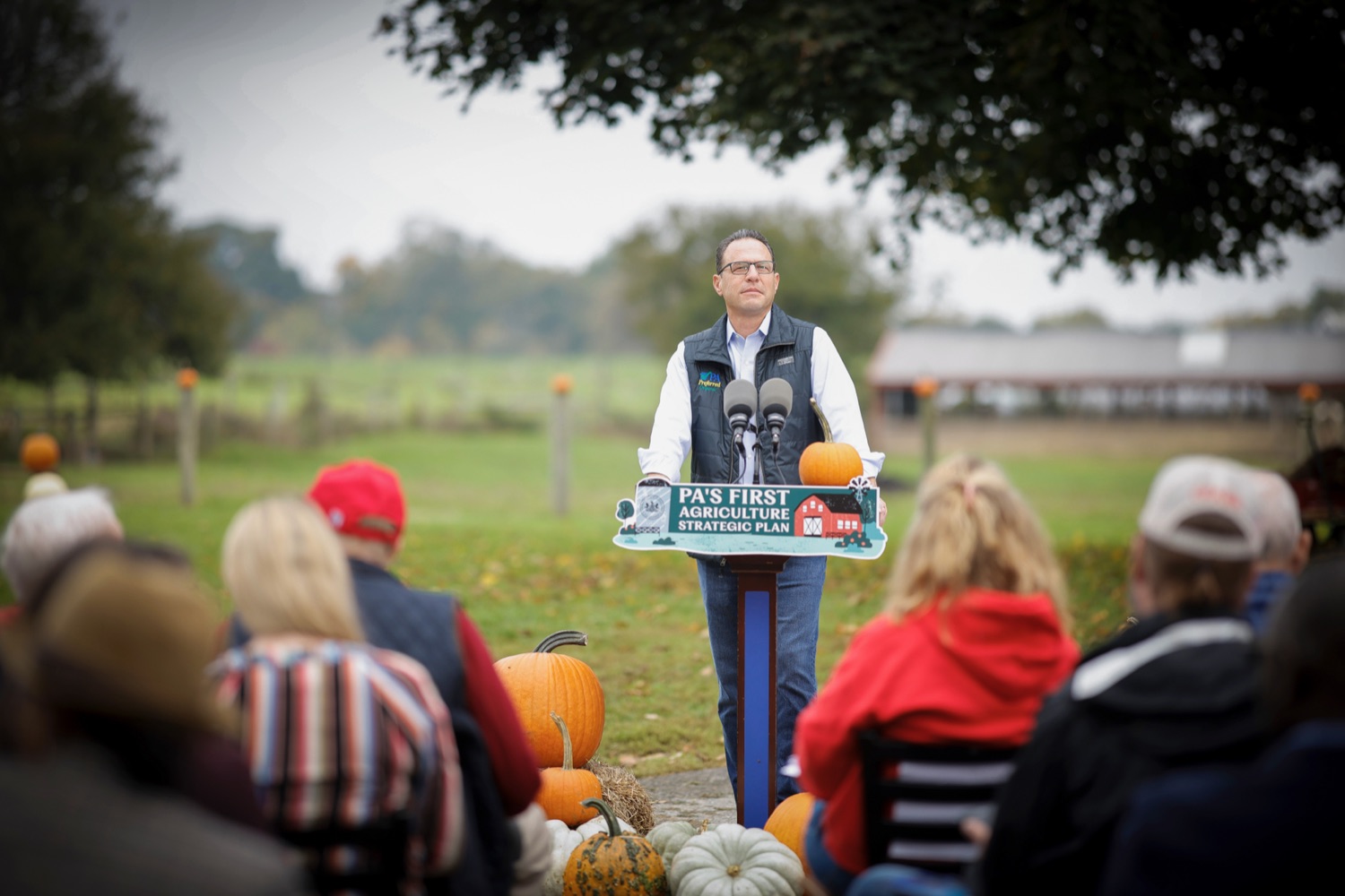 Governor Shapiro speaks at a podium at a farm.