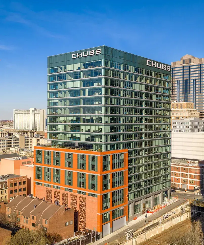 Modern glass office tower in city skyline