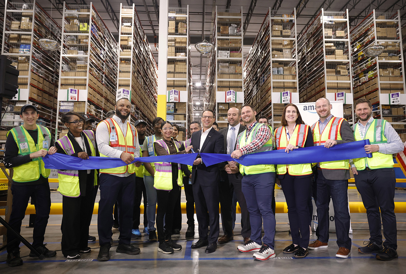 Governor Josh Shapiro with Amazon Employees holding the ribbon during inauguration